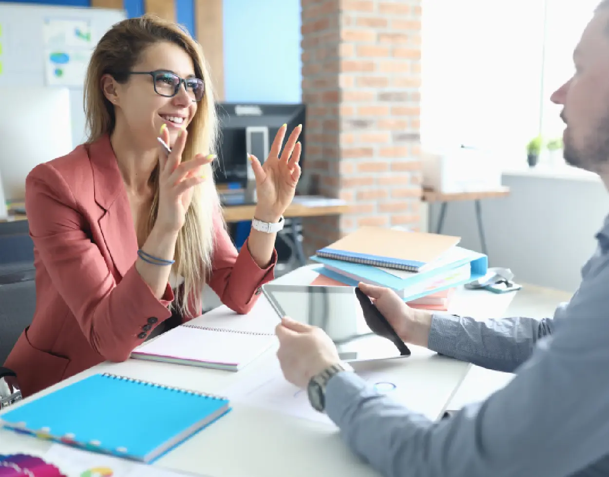 A woman clapping at an office meeting