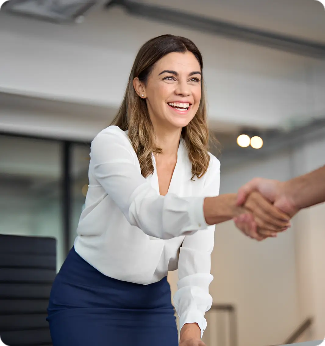 A woman shaking hands with another person.