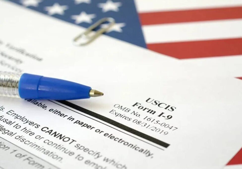 A pen and paper on top of an american flag.
